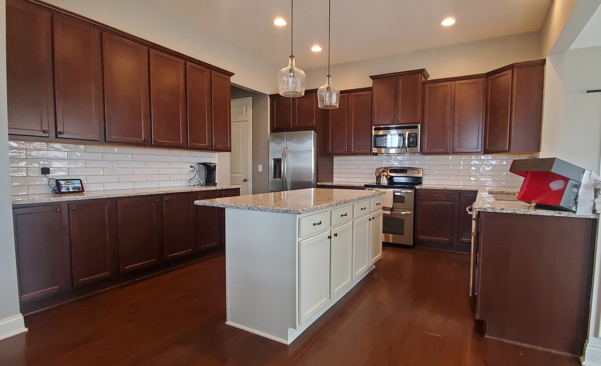 Cherry kitchen cabinets with white island before Cherry kitchen cabinets with white island before — Segor Painting, Columbus OH