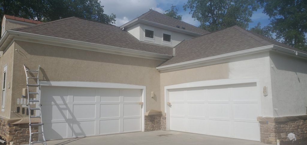 Stucco house garage doors painting in progress — Segor Painting, Columbus OH