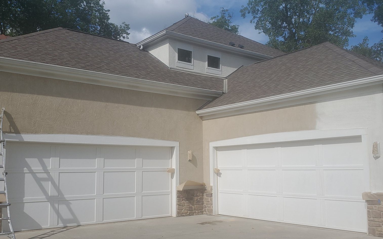 Stucco house garage doors painting in progress Stucco house garage doors painting in progress — Segor Painting, Columbus OH